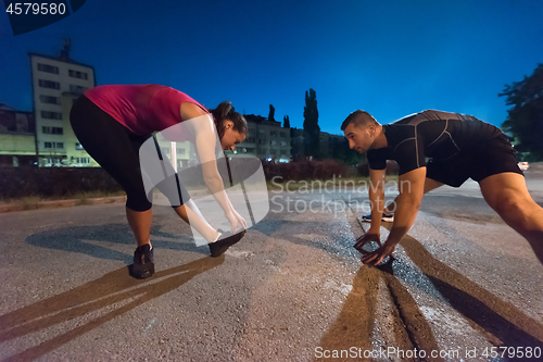 Image of couple warming up and stretching