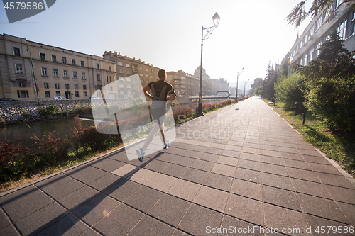 Image of man jogging at sunny morning