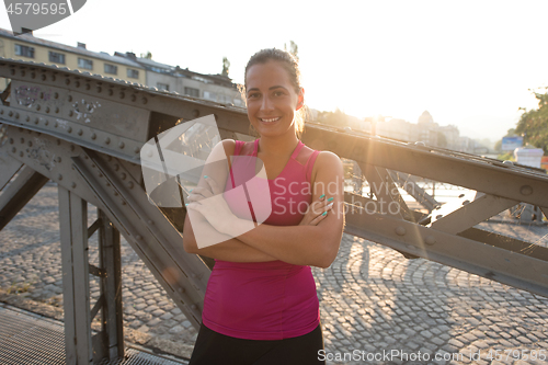 Image of portrait of a jogging woman at sunny morning