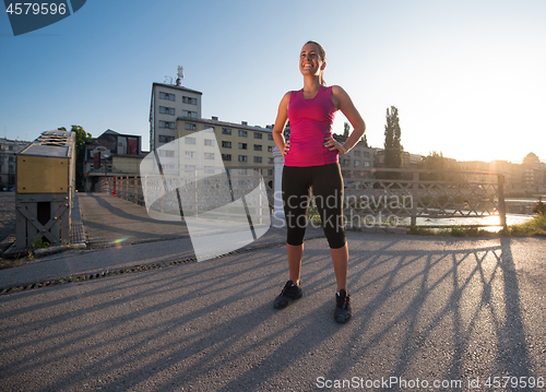 Image of portrait of a jogging woman at sunny morning