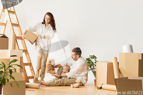 Image of Couple moving to a new home - Happy married people buy a new apartment to start new life together