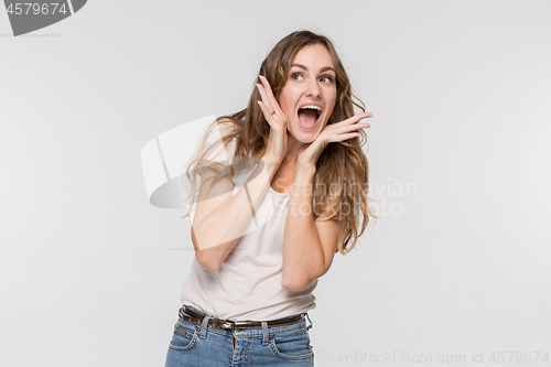 Image of Beautiful woman looking suprised isolated on white