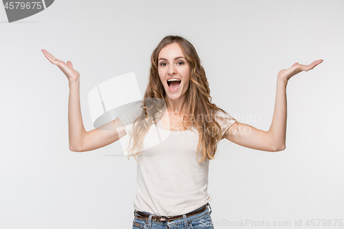 Image of Beautiful female half-length portrait isolated on studio backgroud. The young emotional surprised woman