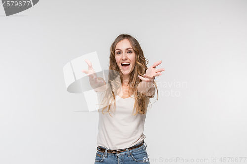 Image of Beautiful female half-length portrait isolated on studio backgroud. The young emotional surprised woman