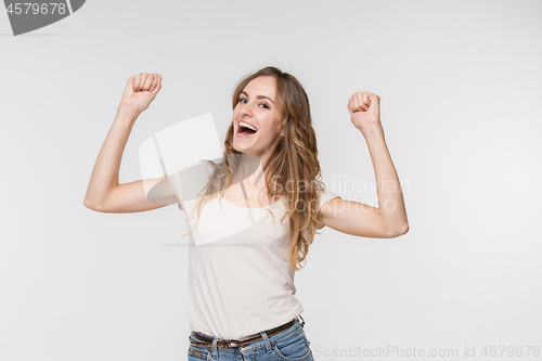 Image of Winning success woman happy ecstatic celebrating being a winner. Dynamic energetic image of female model