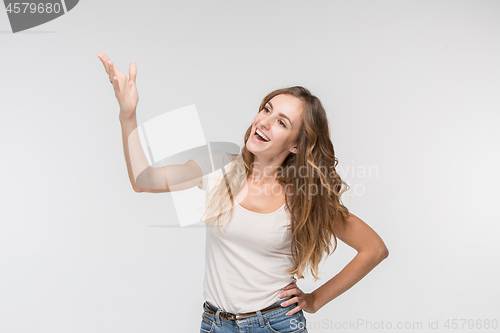 Image of Beautiful female half-length portrait isolated on studio backgroud. The young emotional surprised woman