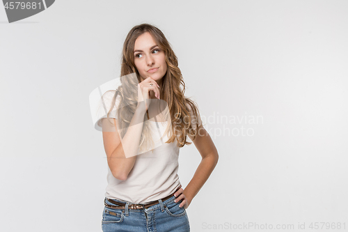 Image of Young serious thoughtful business woman. Doubt concept.