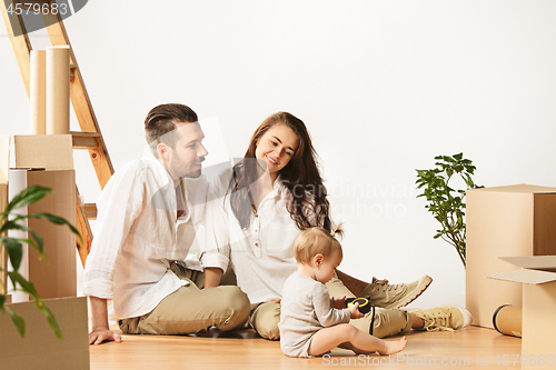 Image of Couple moving to a new home - Happy married people buy a new apartment to start new life together