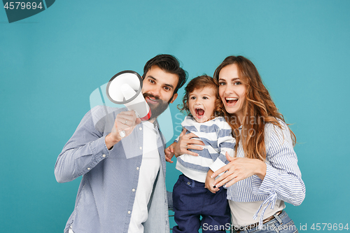 Image of happy father and son playing together with soccer ball on white