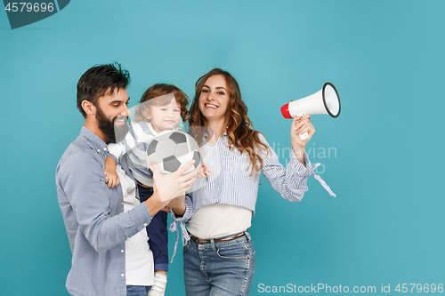 Image of happy father and son playing together with soccer ball on white