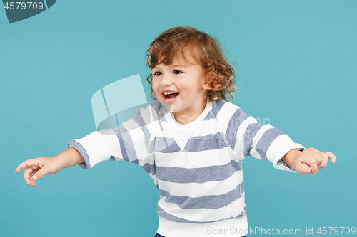 Image of Portrait of happy joyful beautiful little boy, studio shot