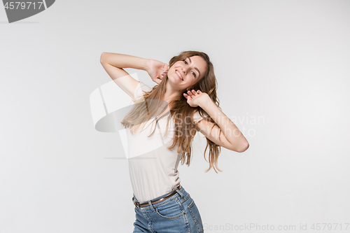 Image of The happy business woman standing and smiling against white background.