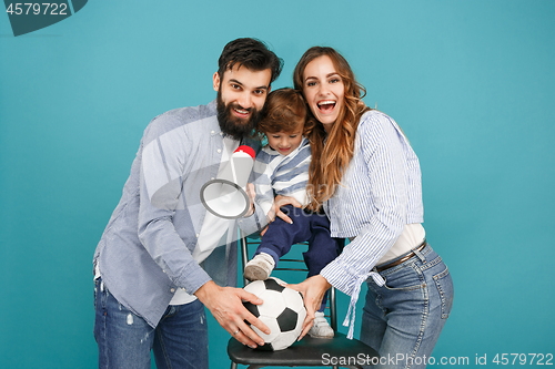 Image of happy father and son playing together with soccer ball on white