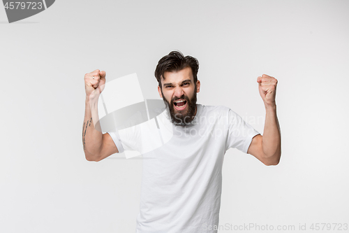 Image of Winning success man happy ecstatic celebrating being a winner. Dynamic energetic image of male model