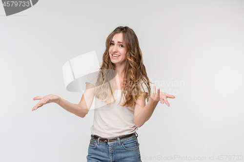 Image of Beautiful woman looking suprised and bewildered isolated on white