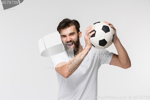 Image of Young soccer player with ball in front of white background