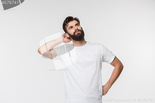 Image of Young serious thoughtful businessman. Doubt concept.