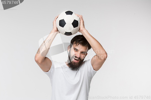 Image of Young soccer player with ball in front of white background