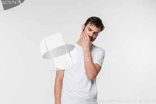 Image of Young man is having toothache.