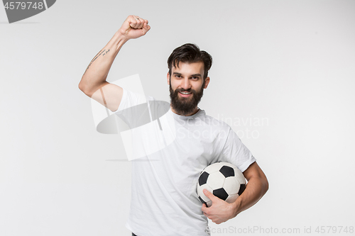 Image of Young soccer player with ball in front of white background