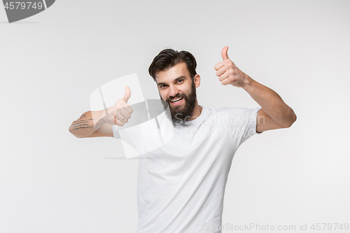 Image of The happy businessman standing and smiling against white background.