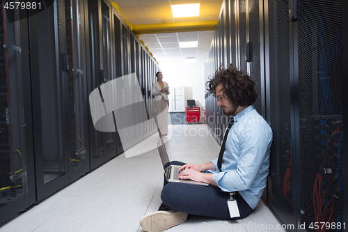 Image of Team of young technicians working together on servers