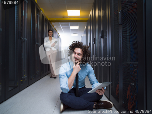 Image of young technicians working together on servers