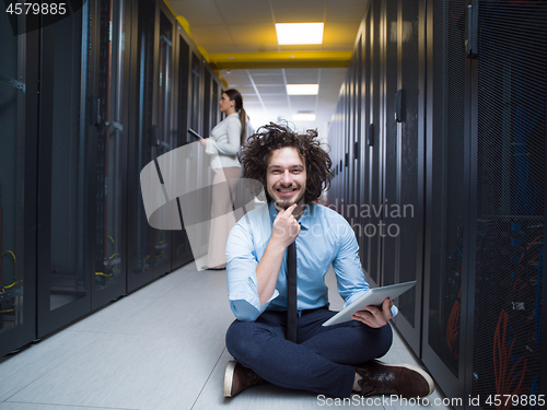 Image of young technicians working together on servers