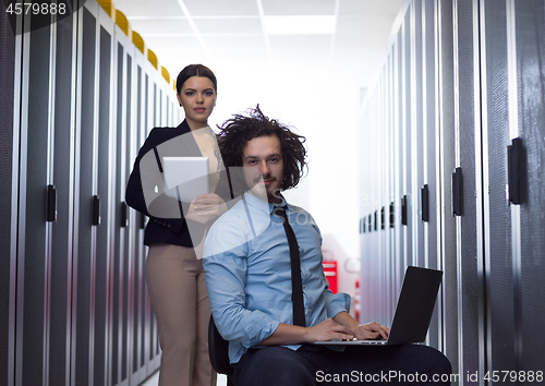 Image of Team of young technicians working together on servers