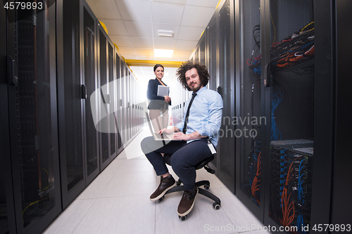 Image of Team of young technicians working together on servers