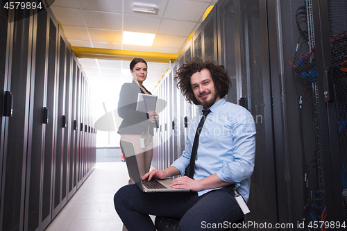 Image of Team of young technicians working together on servers