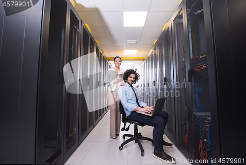 Image of Team of young technicians working together on servers