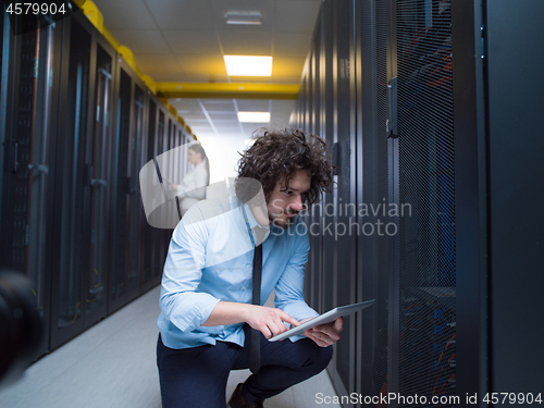 Image of young technicians working together on servers