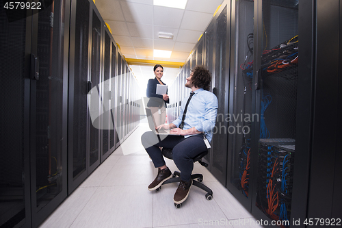 Image of Team of young technicians working together on servers