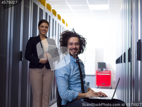 Image of Team of young technicians working together on servers