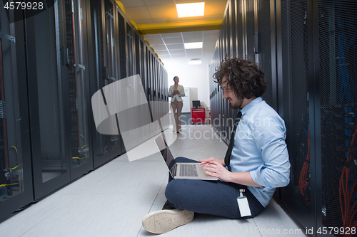 Image of Team of young technicians working together on servers