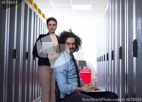 Image of Team of young technicians working together on servers