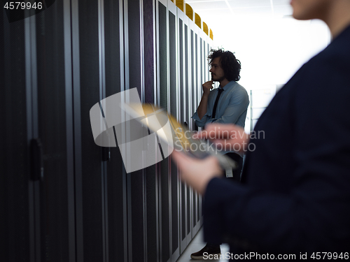 Image of Female engineer working on a tablet computer in server room