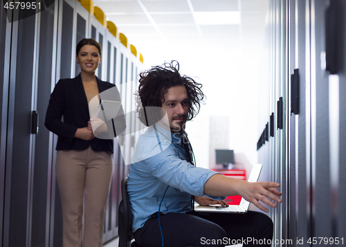 Image of Team of young technicians working together on servers