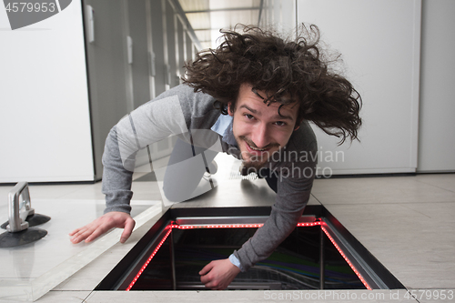 Image of engineer connecting cables in server room