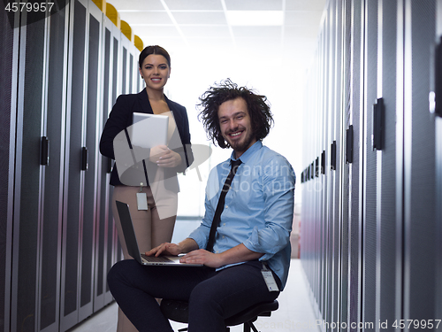 Image of Team of young technicians working together on servers