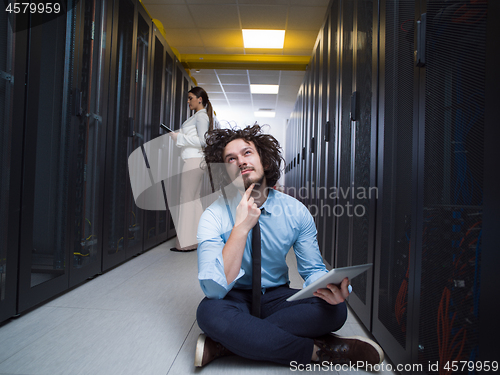 Image of young technicians working together on servers