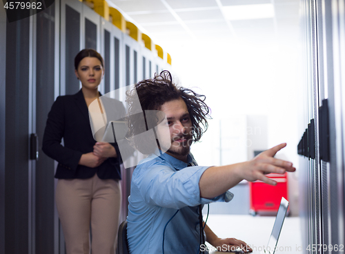 Image of Team of young technicians working together on servers