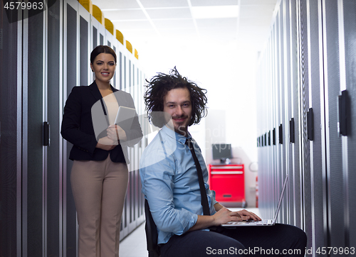 Image of Team of young technicians working together on servers