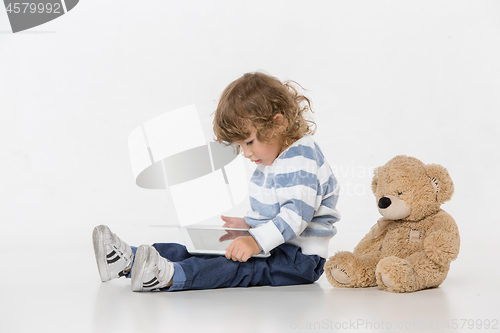 Image of Portrait of happy joyful beautiful little boy sitting with laptop