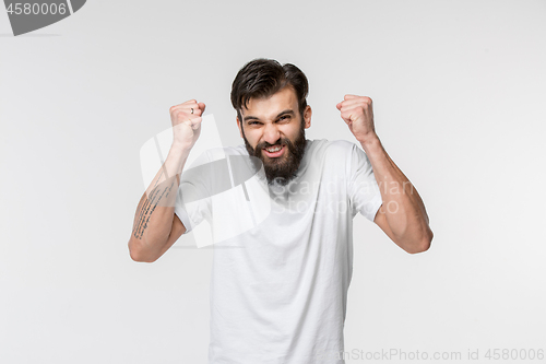 Image of Winning success man happy ecstatic celebrating being a winner. Dynamic energetic image of male model