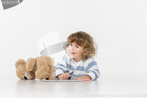Image of Portrait of happy joyful beautiful little boy sitting with laptop