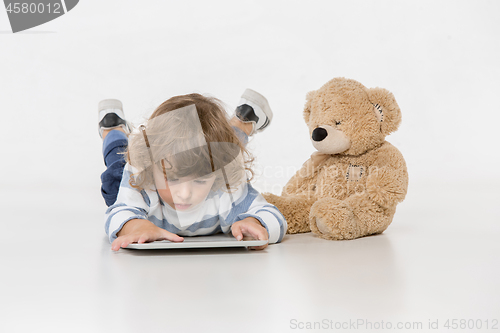 Image of Portrait of happy joyful beautiful little boy sitting with laptop