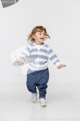 Image of Portrait of happy joyful beautiful little boy, studio shot