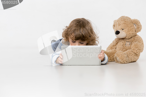 Image of Portrait of happy joyful beautiful little boy sitting with laptop